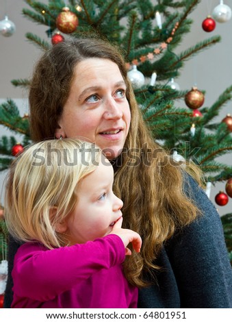 mother and daughter in front of christmas tree