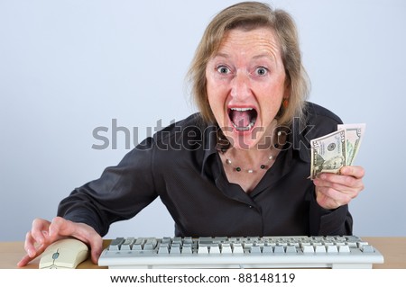 woman with money is screaming in to computer
