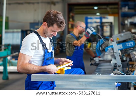 two worker in factory on the machine