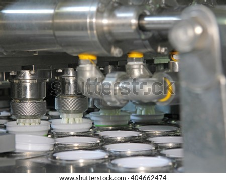 Production of yogurt in a dairy factory, industrial equipment for filling in plastic cups