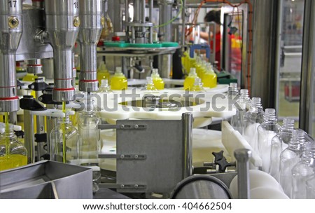 Liquid detergent on automated production line. Machinery for bottling