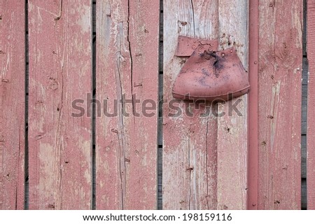 Old red wooden garage door with peeling paint