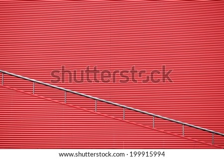 red wall and red staircase. red wall background, architectural fragment, red wall with the stairs.