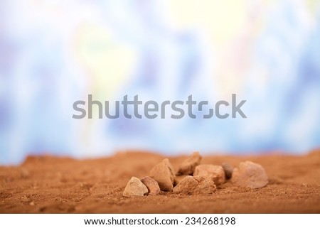 Close up red desert sand with wold map background.