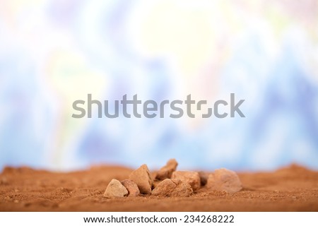 Close up red desert sand with wold map background.