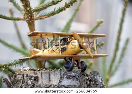 Close-up of  a wooden toy plane hand carved model on old wood