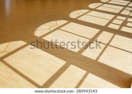 Sunlight from window falling on wooden floor in dance hall loft interior