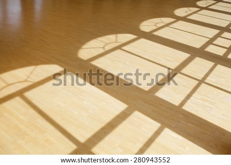 Sunlight from window falling on wooden floor in dance hall loft interior