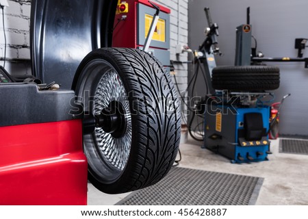 Car wheel balancing in tire service.