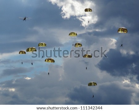 Many paratroopers dropped on the battlefield in Europe. Dramatic scenery.