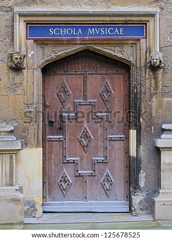 Carved wooden door at entrance to School of Music, Bodleian Library, Oxford, United Kingdom.