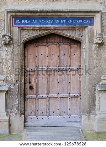 Carved wooden door at entrance to School of Astronomy and Rhetoric, Bodleian Library, Oxford, United Kingdom.