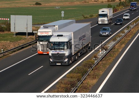 PILSEN, CZECH REPUBLIC - OCTOBER 1, 2015: Dangerous overtaking of two trucks on D5 highway. Cause of frequent car accident. The D5 is important transport connection between West Bohemia and Germany.