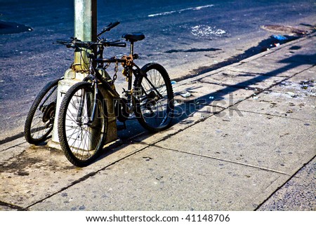 two bikes locked on sidewalk