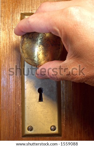 Hand turning door knob on old style door