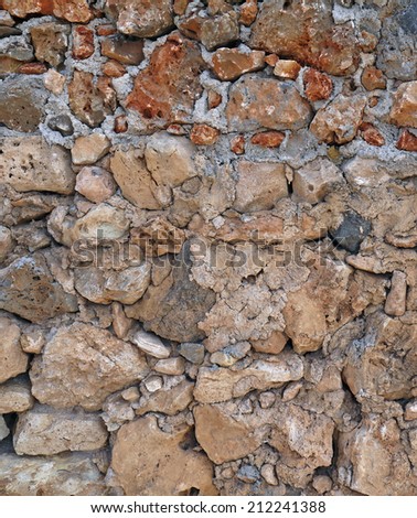 Background of stone wall texture. (in the picture has been processed electronically and selective lighting)