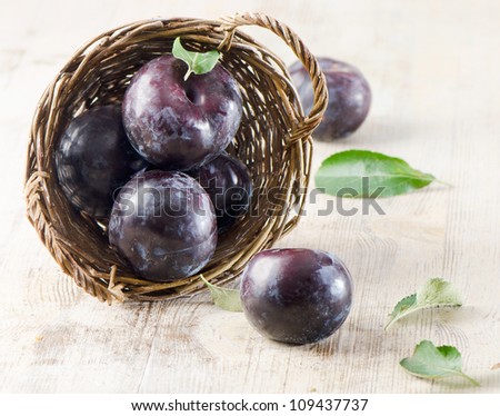 Group of plums in basket