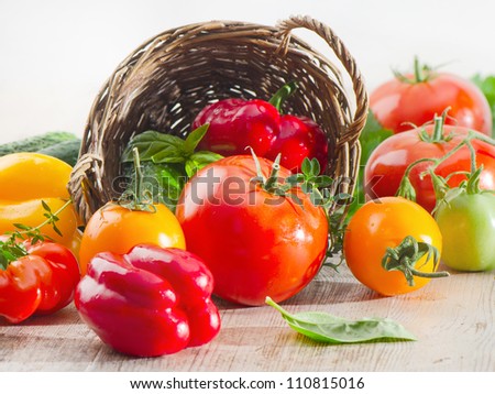 Fresh tomatoes and peppers  on a wooden table