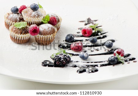 Cupcakes  with fresh berries and sweet chocolate  christmas tree