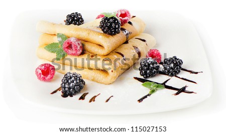 Crepes with berries and mint isolated on white