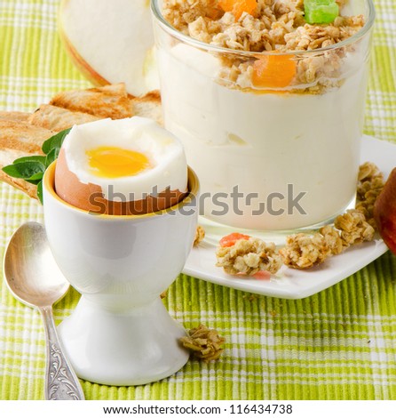Healthy breakfast - boiled egg , yogurt with muesli