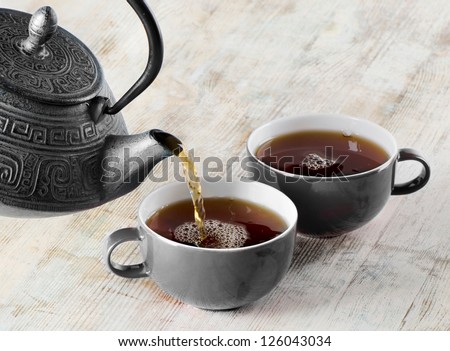 Tea being poured into tea cup