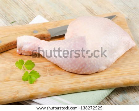 Chicken leg on a wooden table