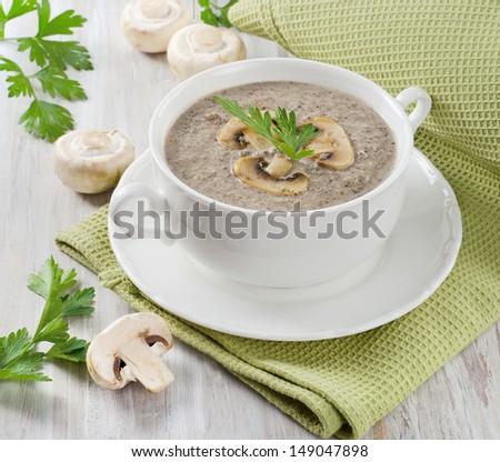 Creamy mushroom soup with fresh herbs. Selective focus
