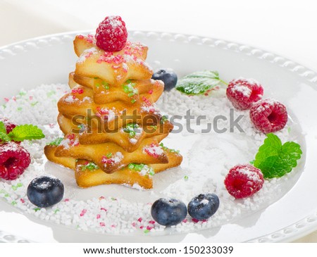 Christmas tree of cookies with berries  on a white plate