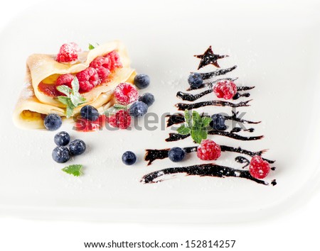 sweet christmas tree with crepes,berries and mint isolated on white
