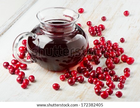 Glass jug of Cranberries juice. Selective focus