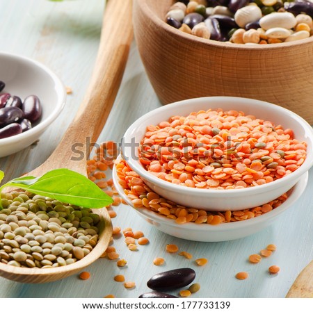 Beans and lentils on a wooden table . selective focus