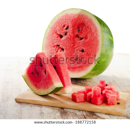 slices of watermelon on wooden table isolated on white
