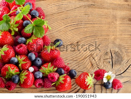 fresh berries mix on a wooden background