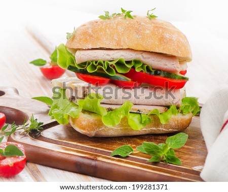 Fresh healthy sandwich  on a wooden cutting board. Selective focus
