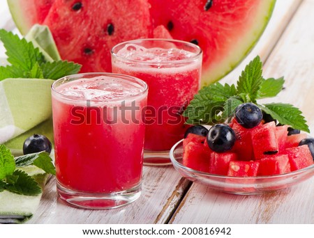 Watermelon smoothie on a wooden table. Selective focus