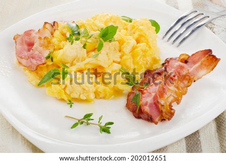 Breakfast - Scrambled eggs and bacon . Selective focus