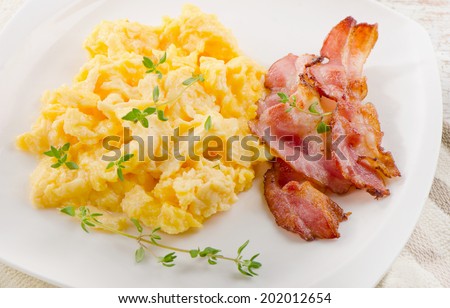 Breakfast - Scrambled eggs and bacon . Selective focus