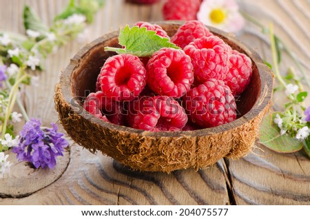 Fresh raspberries  with leaves and flowers. Selective focus