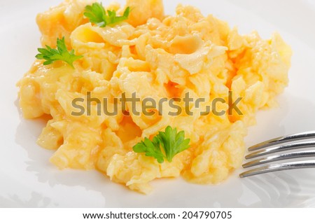 Scrambled eggs with fresh herbs. Selective focus