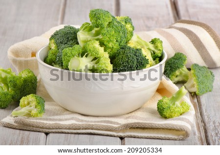 Fresh green broccoli  on a  wooden table. Selective focus