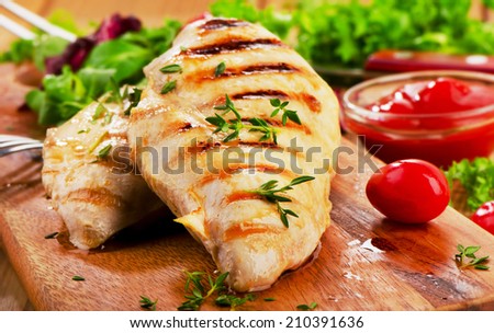 Grilled chicken breast with fresh vegetables . Selective focus