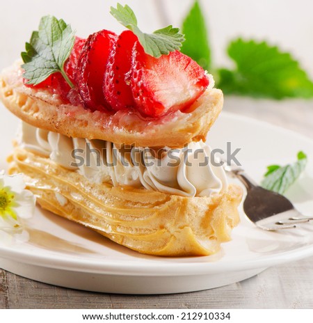 Sweet cream puff with strawberries. Selective focus