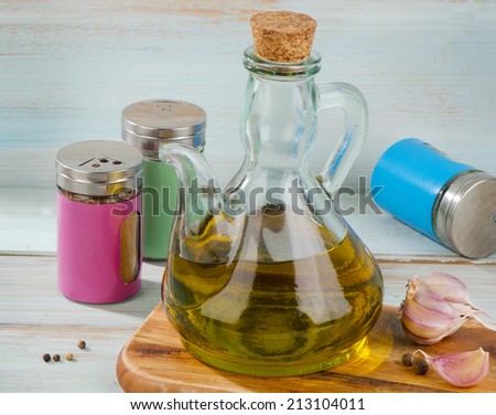 Olive oil and spices on a wooden table. Selective focus
