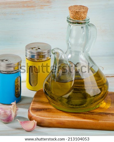 Olive oil and spices on a wooden table. Selective focus