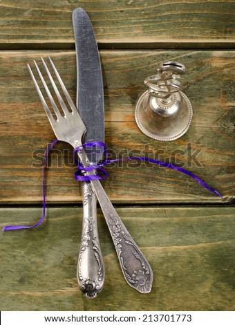 Old fork and knife on a wooden table