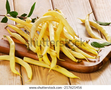 yellow beans on a wooden board. Selective focus
