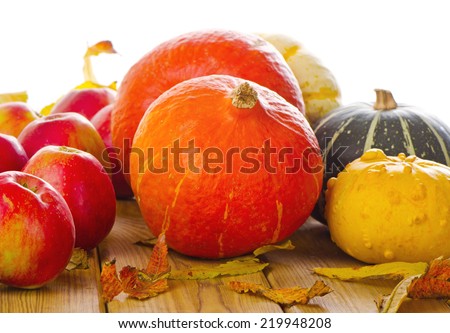 Orange Pumpkins with apples and  fall leaves isolated on white. Selective focus