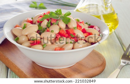 White bean salad  on a wooden table. Selective focus