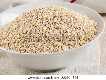 Healthy Oat bran in  white bowl. Selective focus